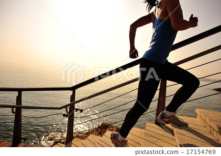 sports woman running up on stone stairs sunrise  17154769
