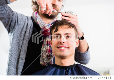 Barber trimming man hair in haircutter shop Barber trimming man hair in haircutter shop 17155141