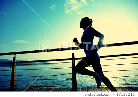 sports woman running on boardwalk sunrise seaside 17155216