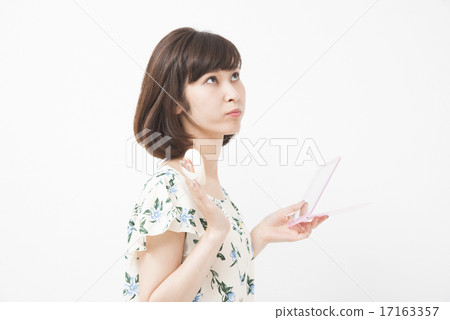 Woman doing make-up Woman doing make-up 17163357
