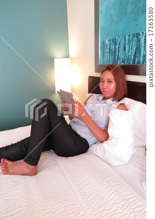 A woman working in a hotel room 17163580