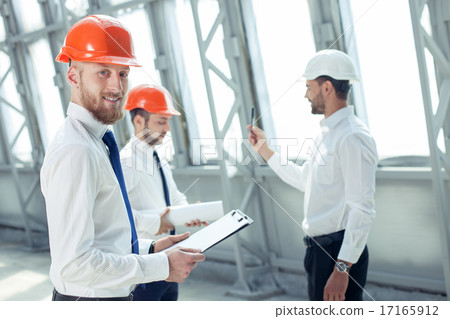 Handsome young builders are working on a new project Handsome young builders are working on a new project 17165912