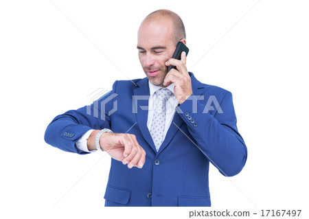 businessman talking on the phone and looking at his watch 17167497