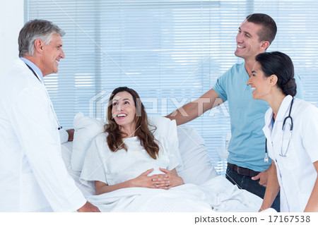 Future parents talking with smiling doctors Future parents talking with smiling doctors 17167538