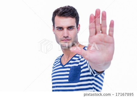 Handsome hipster looking at camera and showing stop sign with ha Handsome hipster looking at camera and showing stop sign with ha 17167895