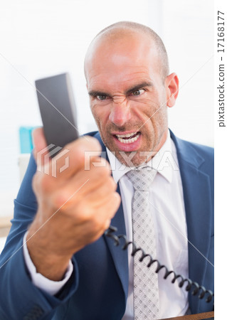 Businessman yelling at his phone Businessman yelling at his phone 17168177