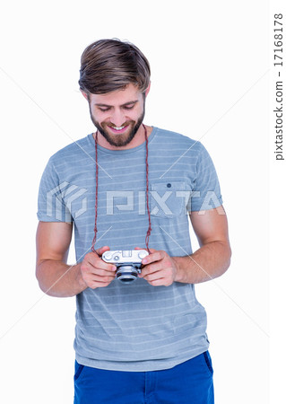 Handsome man looking at his photo camera 17168178