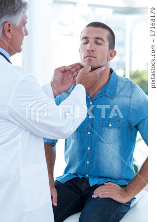 Doctor examining his patients ganglion 17168179