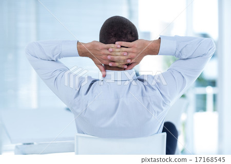 Rear view of businessman relaxing in a swivel chair 17168545