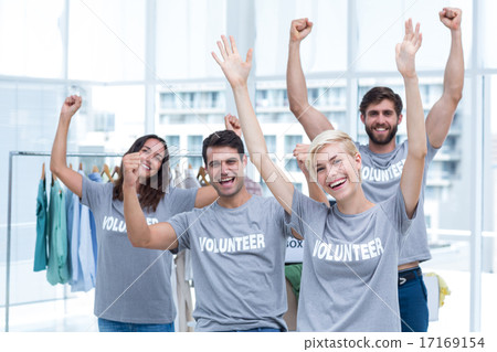 Happy volunteers friends raising arms 17169154