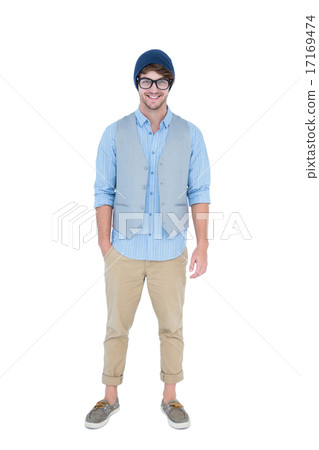 Geeky hipster looking at camera with hand in pocket 17169474