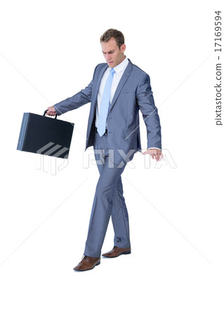 Businessman walking in equilibrium with suitcase Businessman walking in equilibrium with suitcase 17169594