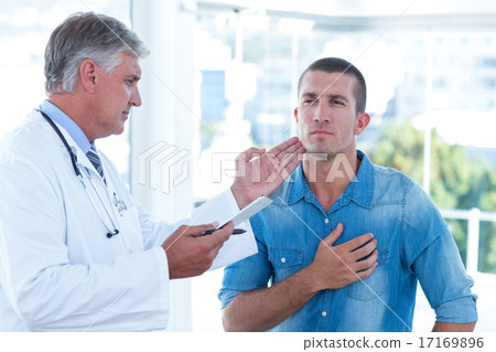 Doctor examining his patients neck 17169896