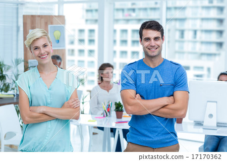 Portrait of creative team with arms crossed in office 17170362