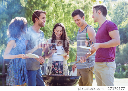 Happy friends in the park having barbecue Happy friends in the park having barbecue 17170577