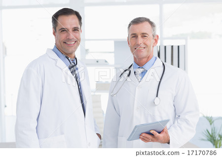 Doctor and his colleague looking at camera Doctor and his colleague looking at camera 17170786