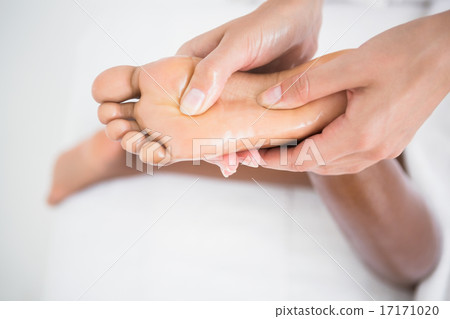 Pretty woman enjoying a foot massage Pretty woman enjoying a foot massage 17171020