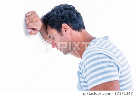 Sad man leaning his head against a wall 17171347