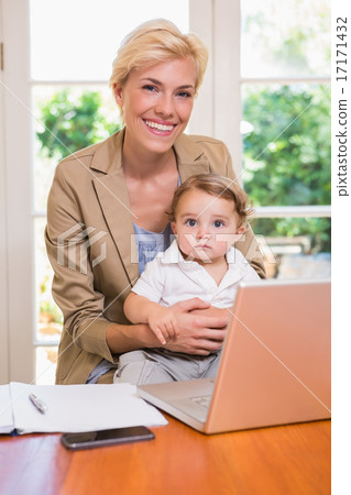 Smiling pretty blonde with his son using laptop Smiling pretty blonde with his son using laptop 17171432