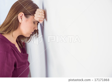 Depressed woman leaning her head against a wall Depressed woman leaning her head against a wall 17171868