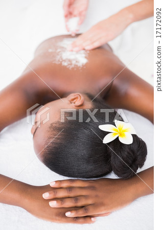 Pretty woman enjoying an exfoliation massage 17172092
