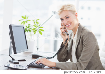 Businesswoman on the phone and using her computer 17172093