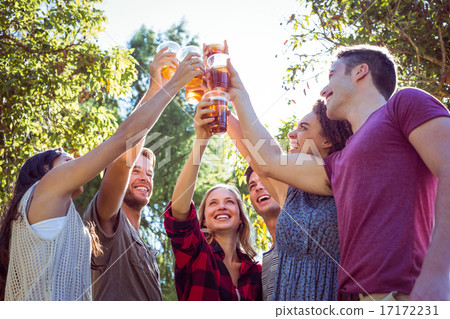 Happy friends in the park having beers 17172231