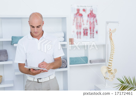 Doctor writing on clipboard Doctor writing on clipboard 17172461