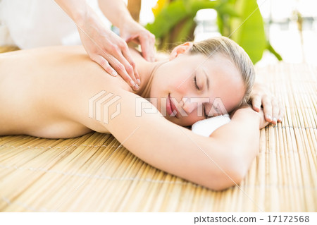 Attractive woman getting massage on her back Attractive woman getting massage on her back 17172568