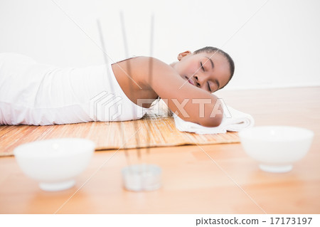 Peaceful pretty woman lying a bamboo mat 17173197