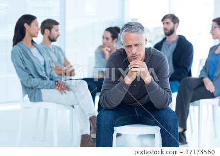 Man comforting another in rehab group at therapy 17173560