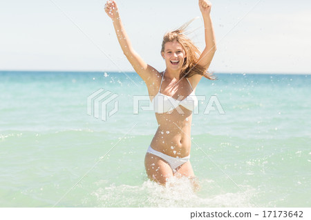 Happy pretty blonde cheering into the sea 17173642