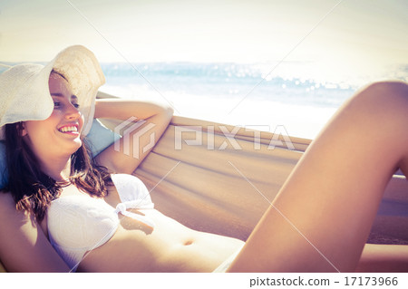 Brunette relaxing in the hammock and smiling at camera Brunette relaxing in the hammock and smiling at camera 17173966