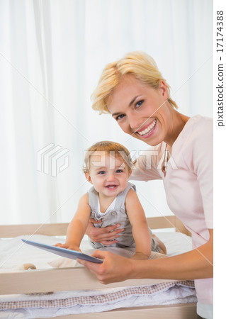 Portrait smiling of blonde with his son using digital tablet 17174388