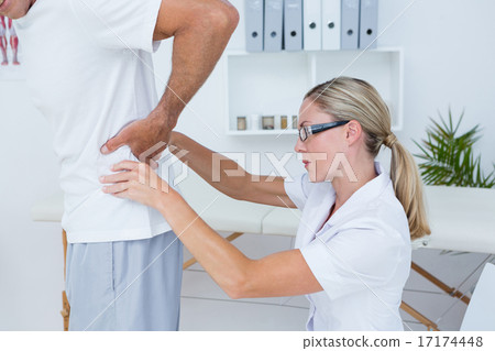 Doctor examining her patient back Doctor examining her patient back 17174448