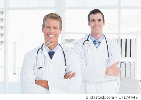 Smiling doctors looking at camera with arms crossed Smiling doctors looking at camera with arms crossed 17174449