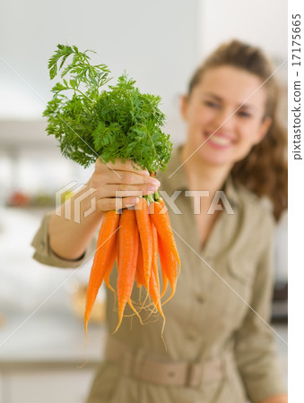 Closeup on fresh carrots in hand of woman 17175665
