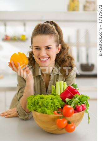Portrait of happy young housewife with plate of fresh vegetables Portrait of happy young housewife with plate of fresh vegetables 17175672