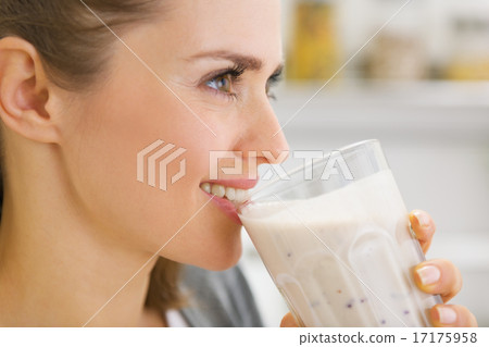 Happy young woman drinking cocktail Happy young woman drinking cocktail 17175958