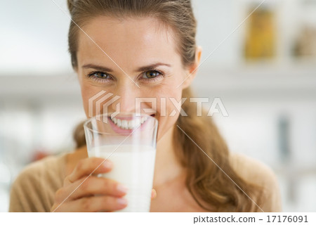 Smiling young woman drinking milk 17176091