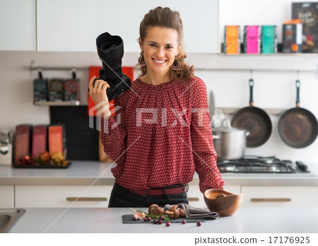 Portrait of smiling female food photographer in kitchen Portrait of smiling female food photographer in kitchen 17176925