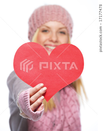 Closeup on heart shaped postcard in hand of teenager girl in win Closeup on heart shaped postcard in hand of teenager girl in win 17177478