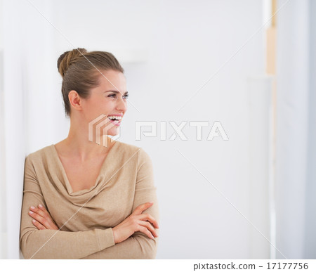 Happy young housewife looking on copy space Happy young housewife looking on copy space 17177756