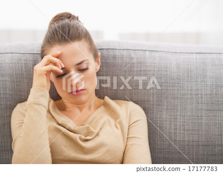 Stressed young woman sitting on sofa Stressed young woman sitting on sofa 17177783
