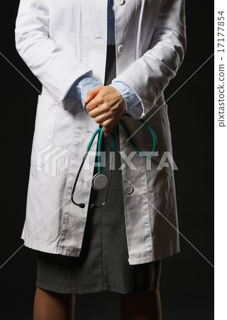 Closeup on stethoscope in hand of doctor woman isolated on black Closeup on stethoscope in hand of doctor woman isolated on black 17177854
