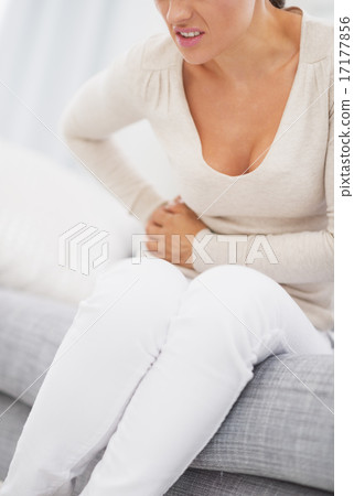 Closeup on young woman having stomach pain Closeup on young woman having stomach pain 17177856