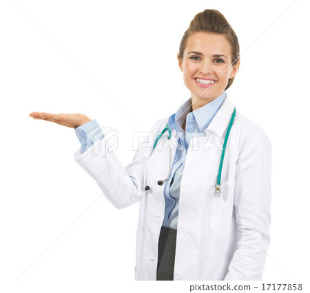 Smiling doctor woman presenting something on empty palm Smiling doctor woman presenting something on empty palm 17177858