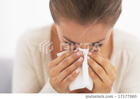 Woman blowing nose into handkerchief Woman blowing nose into handkerchief 17177860