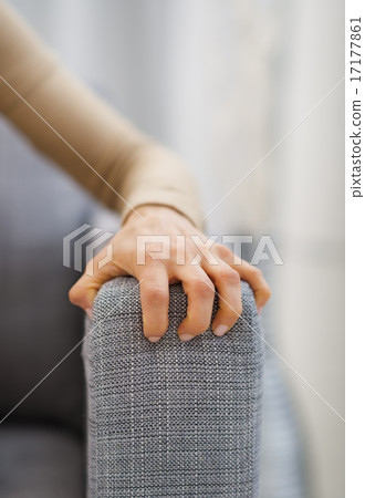 Closeup on hand of stressed woman sitting on sofa Closeup on hand of stressed woman sitting on sofa 17177861