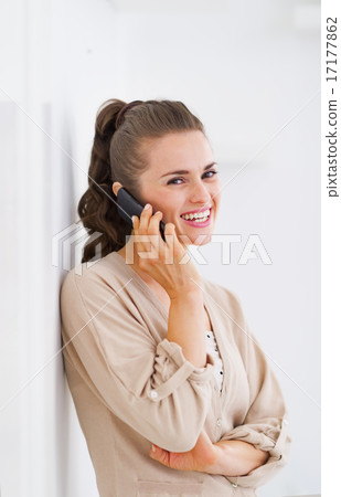 Smiling young woman talking cell phone Smiling young woman talking cell phone 17177862